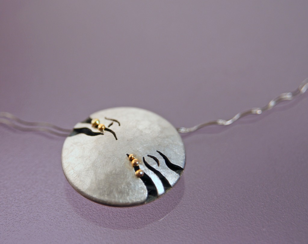 silver and fine gold pendant with the letters H and P