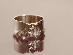 welded silver ring with white topaz in gold setting