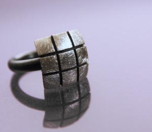 Silver ring with oxidized band and ice-finish