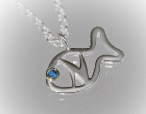 silver pendant with blue sapphire in a yellow gold setting with the letter N