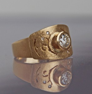 gold and diamond ring adorned with floral ajour ornaments