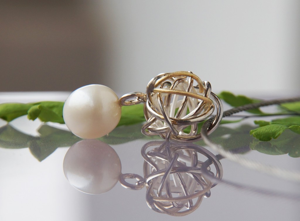 silver and yellow gold knot pendant with sea pearl