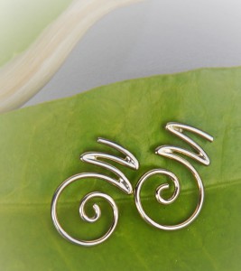 white gold earrings with the ornamental letter "M"