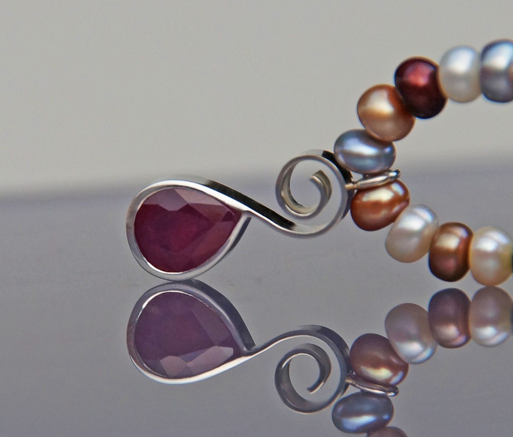 freshwater pearl necklace with ruby in a silver setting