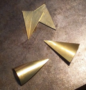 I'm making yellow gold pearls earrings. The first step is sawing four identical triangles from a flat sheet of gold. 