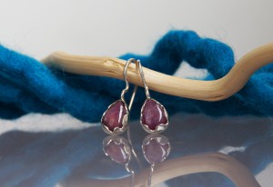 silver ruby earrings with a wavy setting